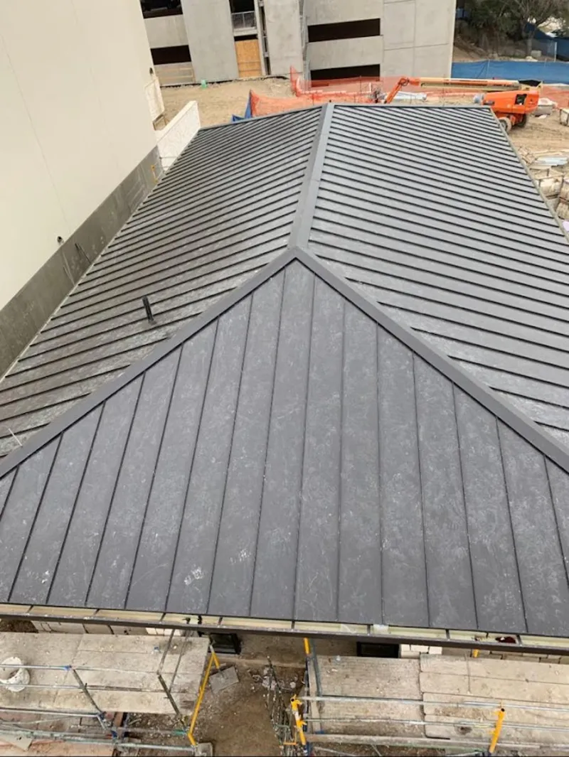 Commercial metal roof construction with crane equipment in Hellam
